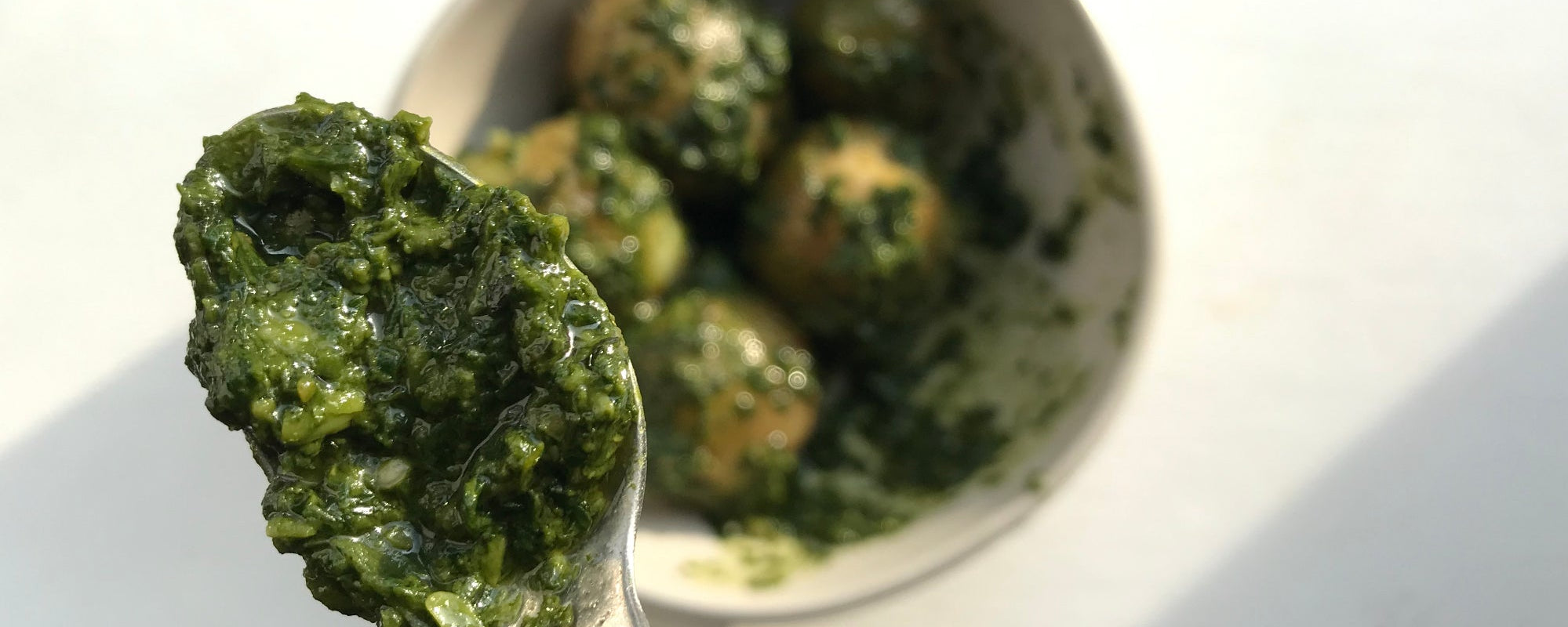 Homemade pesto on young potatoes.