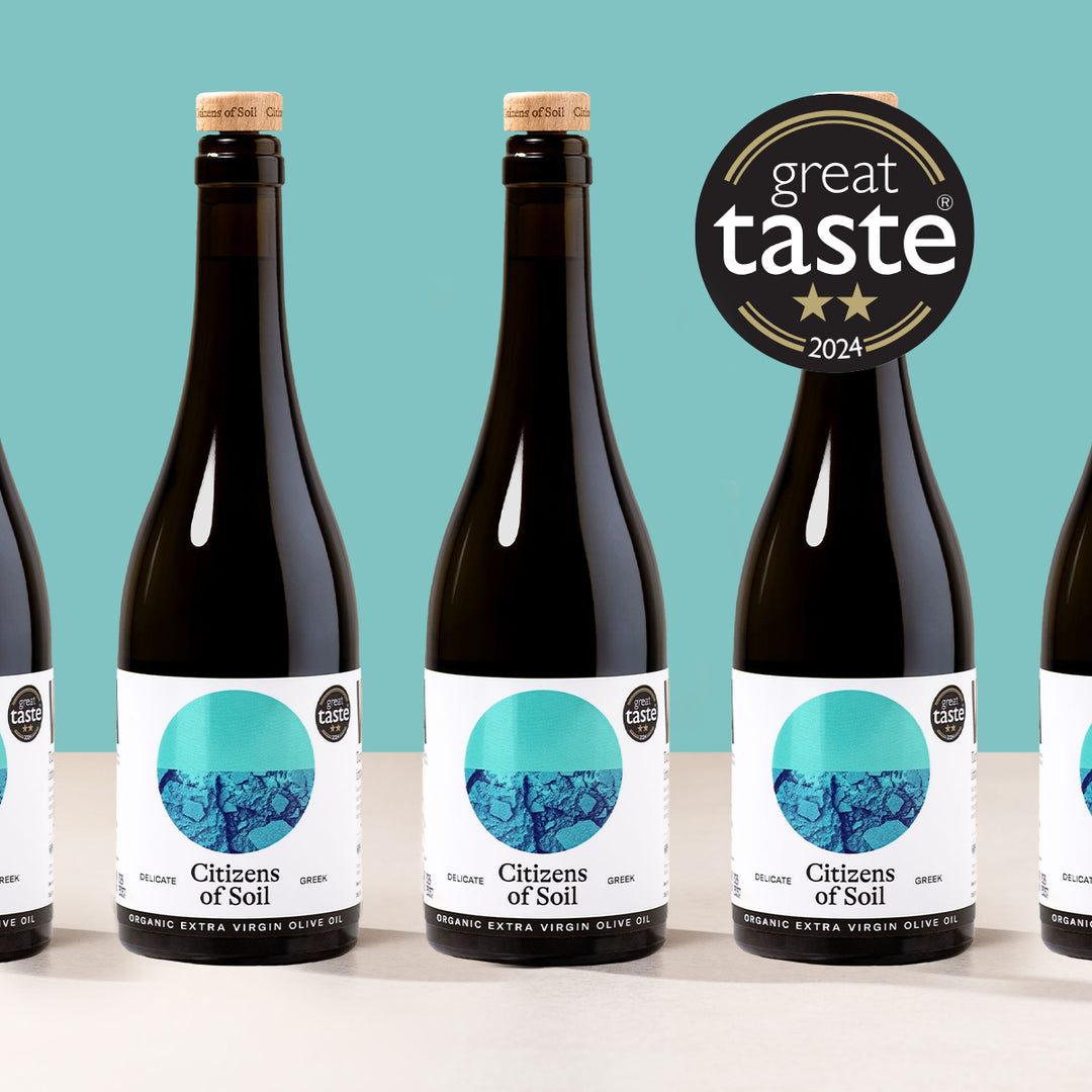 Bottles of Citizens of Soil olive oil with a 'Great Taste' award on a teal background